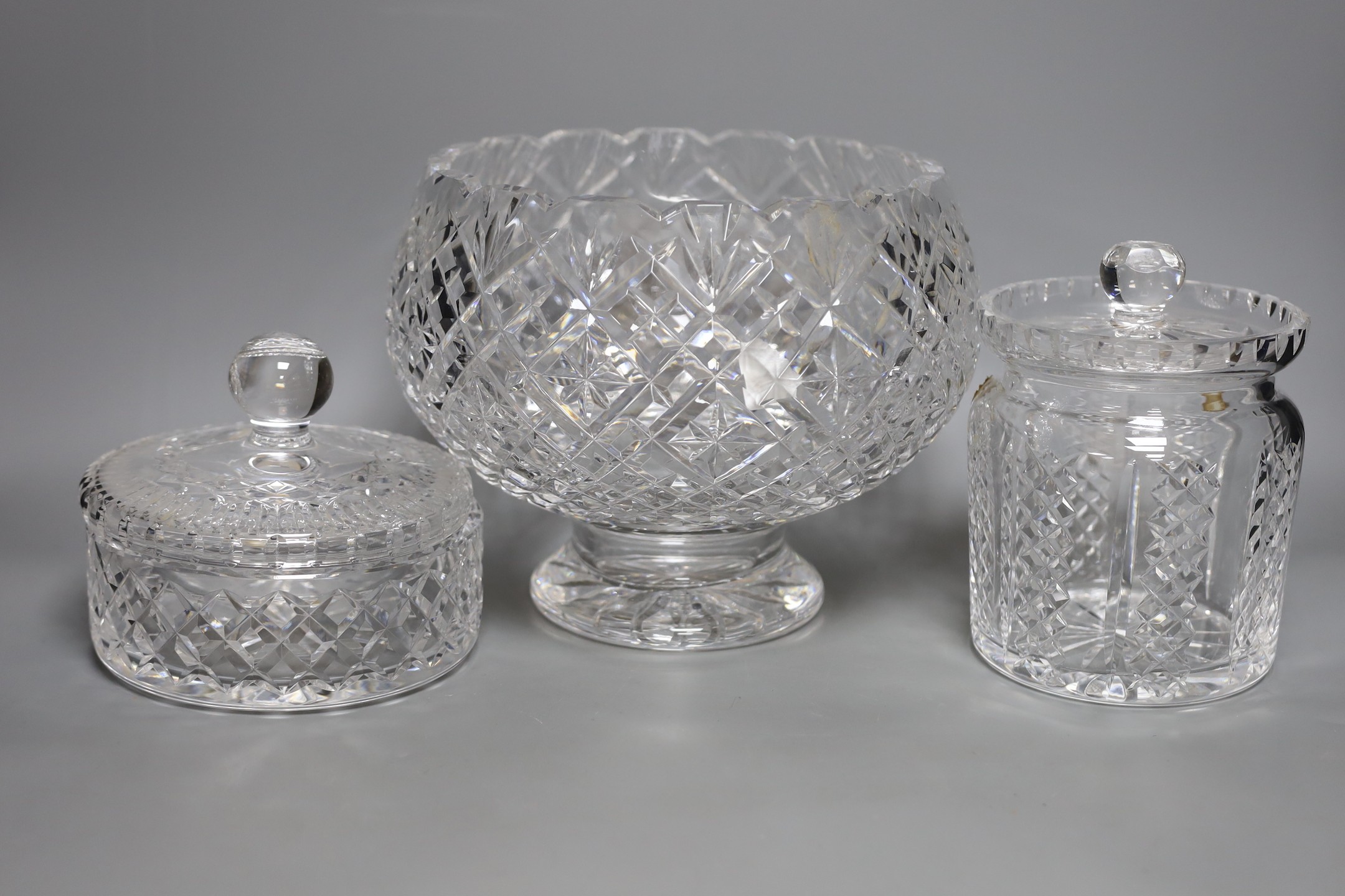 Two Waterford jars and covers and a pedestal vase, Vase 20 cms high